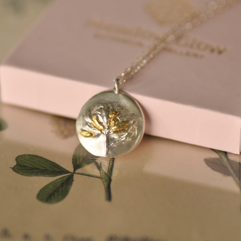 fine silver necklace with golden accents
