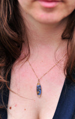 wearing a gold filled necklace